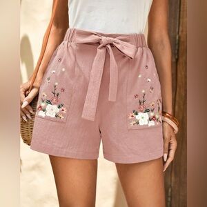 Emery Rose front tie shorts with embroidery at pockets.